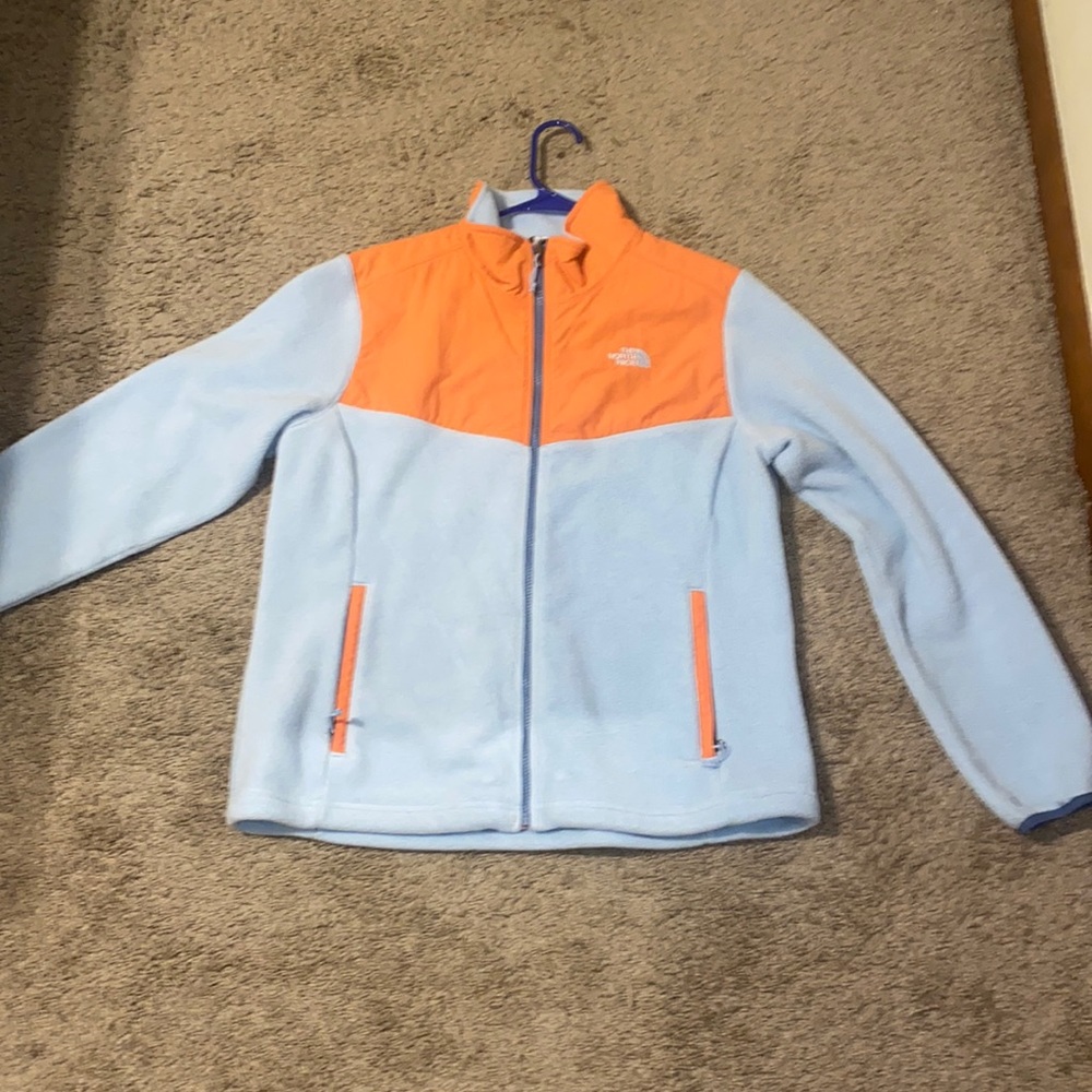 size large north face jacket. fleece like material. light blue and orange colors